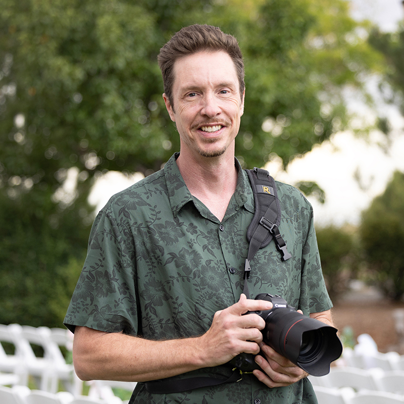 Albuquerque, New Mexico wedding photographer, William Benton, in front of the ceremony site at the Sandia Resort Event Center holding a Canon R5 with a 50mm 1.2 lens